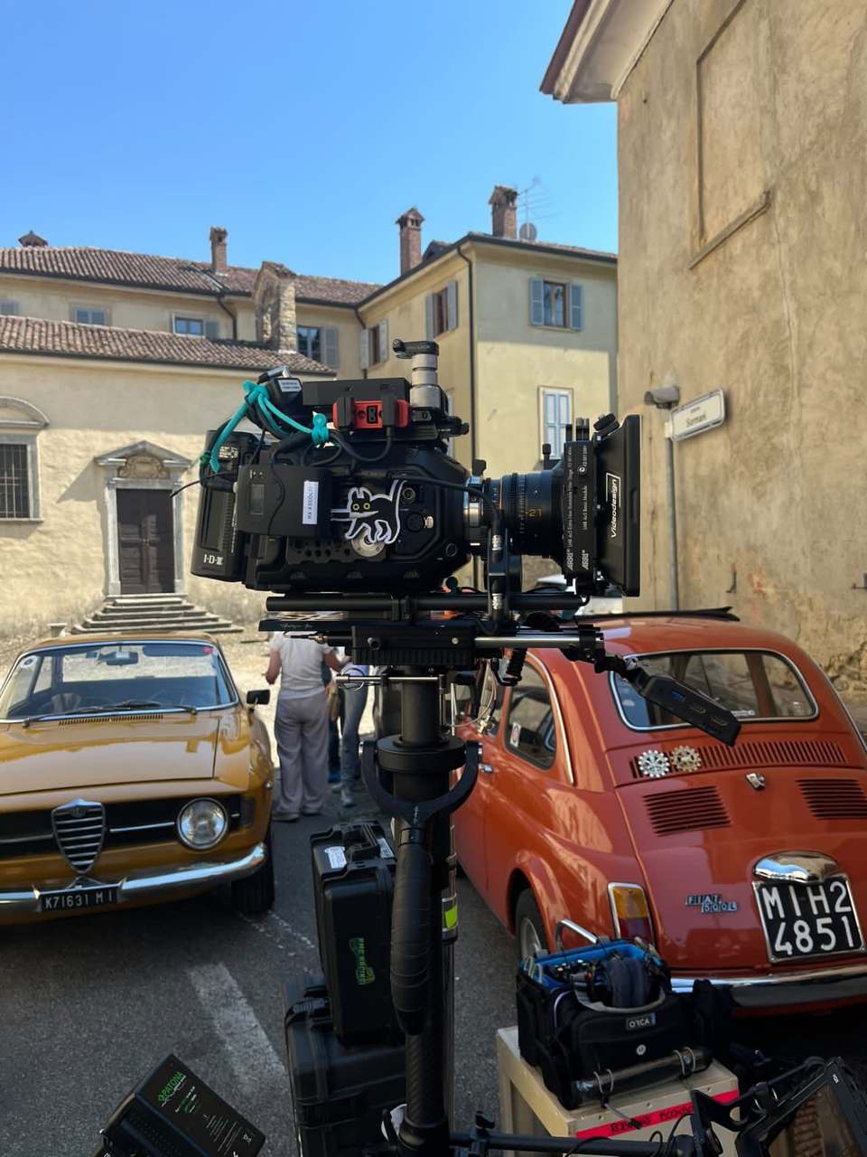 The camera, and the period cars, on a village street